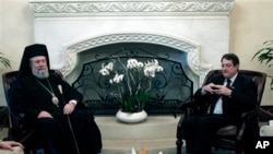 Presiden Siprus Nicos Anastasiades (kanan) menemui Uskup Agung Chrysostomos II di Istana Kepresidenan Siprus di Nicosia (20/3). Pemimpin gereja Orthodoks Siprus menawarkan aset-aset gereja untuk membantu Siprus mengatasi krisis finansial di negara itu.