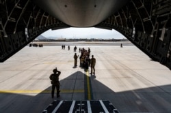 FILE - A U.S. Air Force security forces maintain a security cordon outside a U.S. Air Force C-17, at Hamid Karzai International Airport, in Kabul, Afghanistan, Aug. 20, 2021. (Senior Airman Taylor Crul/U.S. Air Force via AFP)