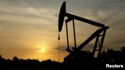 FILE - An oil pump is seen in Lagunillas, Ciudad Ojeda, in the state of Zulia, Venezuela, March 2015.