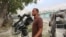 FILE - Somali Freelance journalist Mohamed Guray holds on to his camera after he was injured in a secondary explosion in front of Dayah hotel in Somalia's capital Mogadishu, Jan. 25, 2017.