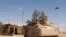 Egyptian Army soldiers in armored personnel carriers and a helicopter gunship patrol through a village in the northern Sinai, Sept. 7, 2013.