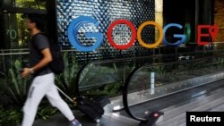 A man passes a Google signage outside their office in Singapore May 24, 2019. (REUTERS/Edgar Su)