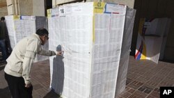 A voter searches for his name in an electoral list at a voting station in Bogota (file photo)