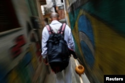 Manoel Pereira Costa, known as "Master Manel", walks in the Rocinha favela in Rio de Janeiro, Brazil, July 25, 2016.