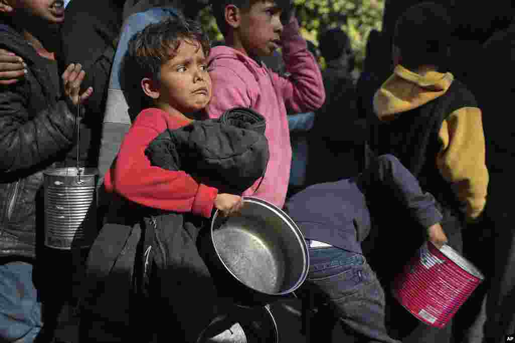 Palestinian children queue for food in Deir al-Balah, Gaza Strip.