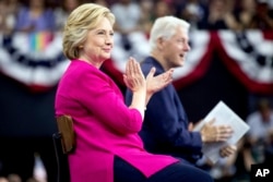 Democratic presidential candidate Hillary Clinton and former President Bill Clinton arrive at Temple University in Philadelphia on July 29, 2016. (AP)