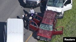 Law enforcement personnel investigate the scene where the Texas bombing suspect blew himself up on the side of a highway north of Austin in Round Rock, Texas, March 21, 2018. 