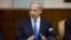 Israeli Prime Minister Benjamin Netanyahu gestures as he speaks at the weekly cabinet meeting in his Jerusalem office, Sept. 8, 2013.
