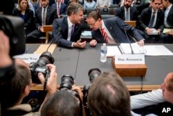 Deputy Attorney General Rod Rosenstein, right, and FBI Director Christopher Wray, left, arrive to testify before a House Judiciary Committee hearing on Capitol Hill in Washington, June 28, 2018.