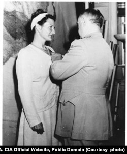 Virginia Hall of Special Operations Branch receiving the Distinguished Service Cross from General Donovan.