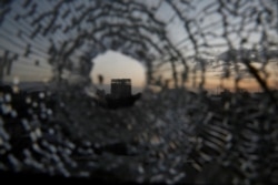 FILE - A building is seen through a bullet hole in a window of the Africa Hotel in the town of Shire, Tigray region, Ethiopia, March 16, 2021.