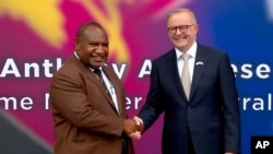 FILE - In this image from a video, Australian Prime Minister Anthony Albanese, left, and Papua New Guinea's Prime Minister James Marape shake hands outside the parliament in Port Moresby, Papua New Guinea, Jan. 12, 2023. 