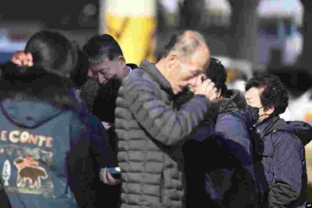 Family members of the passengers on the plane which burst into flames weep at the Muan International Airport, Dec. 29, 2024.