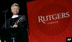 Rock star and philanthropist Jon Bon Jovi performs a new song during graduation ceremonies at Rutgers University-Camden Thursday, May 21, 2015, in Camden, N.J.