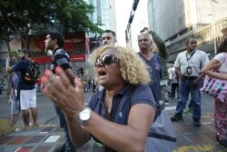FILE - People shout slogans against Venezuela's President Nicolas Maduro during a blackout in Caracas, March 9, 2019.