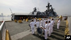 A Philippine Navy Band plays as the Russian Navy vessel Admiral Tributs, a large anti-submarine ship, docks at Manila's pier, Philippines, Jan. 3, 2017. Two Russian Navy Vessels are in the country for a goodwill visit until Jan. 7.