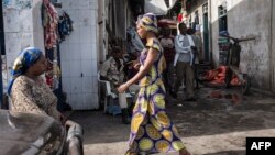FILE - People walk through the Birere market in Goma, March 26, 2015. 