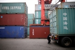 한국 인천항에서 운송회사 관계자가 중국발 컨테이너를 점검하고 있다.