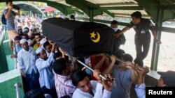 People attend a funeral of U Khin Maung Latt, 58, National League for Democracy (NLD party member in Yangon, Myanmar, March 7, 2021.