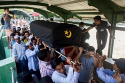 People attend a funeral of U Khin Maung Latt, 58, National League for Democracy (NLD party member in Yangon, Myanmar, March 7, 2021.