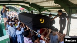 People attend a funeral of U Khin Maung Latt, 58, National League for Democracy (NLD party member in Yangon, Myanmar, March 7, 2021.