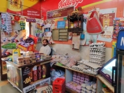 A grocery store owner in a residential complex is happy that he has not had to close down. (Anjana Pasricha/VOA)