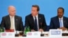 Britain's Prime Minister David Cameron (C) sits with Foreign Secretary William Hague (L) and Somali President Hassan Sheikh Mohamud, as he speaks at the Somalia conference in London, May 7, 2013. 