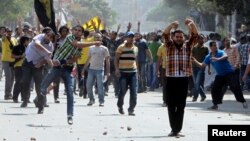 Supporters of deposed President Mohamed Mursi and the Muslim Brotherhood clash with anti-Mursi protesters during a march in Cairo, Oct. 4, 2013. 