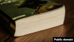 "The book is on the table" is an example of when the preposition "on" is correct and "onto" cannot be used.