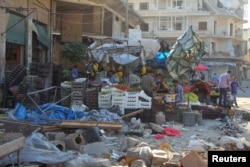 Damage is seen near produce stands after airstrikes on a market in the rebel-controlled city of Idlib, Syria, Sept. 10, 2016.