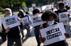 FILE - People protest against the death of George Floyd who died in police custody in Minneapolis, next to the U.S. embassy in Paris, France, June 1, 2020.