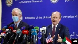 FILE - U.S. Sens. Chris Coons, D-Del., right, and Chris Van Hollen, D-Md., talk to reporters at the Corinthia Hotel in Khartoum, Sudan, May 5, 2021. 