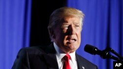 FILE - President Donald Trump, shown speaking at the Department of Homeland Security in Washington, Jan. 25, 2017, said on Twitter that he wanted a voter fraud probe to look at "those registered to vote in two states, those who are illegal and even those registered to vote who are dead."