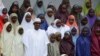 Nigerian President Muhammadu Buhari with school girls released from Boko Haram captivity, Abuja, March 23, 2018. (Azeez Akunleyan/AP)