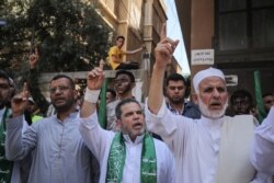Palestinian Hamas supporters take part in a protest against Israel's plan to annex parts of the occupied West Bank, in Khan Yunis in the southern Gaza Strip on June 26, 2020.