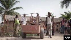 A Central African Republic family moves their belongings as they leave after four years spent in a refugee camp in Betou, northern Congo-Brazzaville, on March 30, 2018, as CAR refugees are taken back to Central Africa Republic.