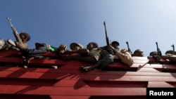 FILE - Militia members from Ethiopia's Amhara region travel to face the Tigray People's Liberation Front, in Sanja, Amhara region, near the border with Tigray, Ethiopia, Nov. 9, 2020. 