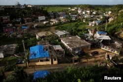 Hurricane Maria destroyed or significantly damaged more than a third of about 1.2 million occupied homes on the island, the government estimates. Damaged houses are seen at squatter community of in Canovanas, Puerto Rico, Dec. 9, 2017.
