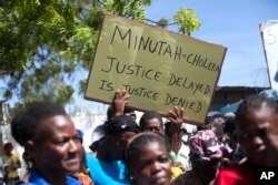 FILE - Cholera survivors protest the United Nations peacekeeping mission outside U.N. headquarters in Port-au-Prince, Haiti, Oct. 15, 2015.