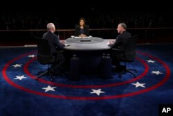 Republican vice-presidential nominee Gov. Mike Pence and Democratic vice-presidential nominee Sen. Tim Kaine discuss a question during the debate.