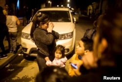 Residents stand on a street outside their houses after an earthquake hit Chile's central zone, Santiago, Sept. 16, 2015.