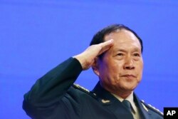 Chinese Defense Minister Gen. Wei Fenghe salutes attendees ahead of the fourth plenary session of the 18th International Institute for Strategic Studies Shangri-la Dialogue, an annual defense and security forum in Asia, in Singapore, June 2, 2019.