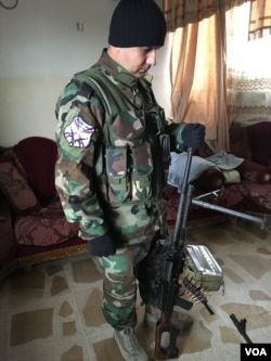 A Dwekh Nawsha fighter holding one of the group's weapons. The Christian militia are defending what they consider their traditional Christian lands just north of Mosul. (S. Behn/VOA)