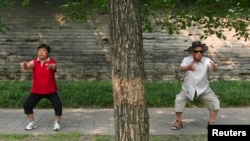 These people are doing a traditional form of Chinese exercise in a Beijing park, 2008. (Reuters/Grace Liang)