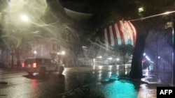 MOBILE, ALABAMA - SEPTEMBER 16: A police vehicle passes through the street as the winds and rain from Hurricane Sally pass through on September 16, 2020 in Mobile, Alabama. Mr. Hollyhand evacuated from his home to spend the night in the hotel. The…