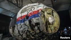 FILE - The reconstructed wreckage of the MH17 airplane is seen after the presentation of the final report on the crash in July 2014 of Malaysia Airlines flight MH17 over Ukraine, in Gilze Rijen, the Netherlands, Oct. 13, 2015. 