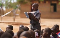 A boy reads aloud during a visit by first lady Melania Trump to Chipala Primary School, in Lilongwe, Malawi, Oct. 4, 2018.