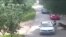 This video frame grab received from China's state broadcaster CCTV on July 25, 2016, shows a tiger (far R) attacking a passenger after she stepped out a car at Beijing Badaling Wildlife World on July 23, 2016.