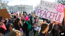 FILE - Women's March demonstrators walk past the White House in Washington, Jan. 20, 2018. (AP Photo/Pablo Martinez Monsivais)