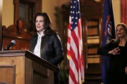 In a photo provided by the Michigan Office of the Governor, Michigan Gov. Gretchen Whitmer addresses the state during a speech in Lansing, Mich., Thursday, Oct. 8, 2020.